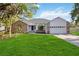 Charming home with a manicured lawn and a two-car garage at 4444 Robin Hood Trl W, Sarasota, FL 34232