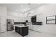Well-lit kitchen featuring stainless steel appliances, granite countertops, and dark island at 4444 Robin Hood Trl W, Sarasota, FL 34232
