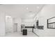 Bright, all white kitchen featuring modern cabinetry, an island, stainless steel appliances and black backsplash at 4444 Robin Hood Trl W, Sarasota, FL 34232
