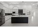 Kitchen with island, stainless steel appliances, mosaic backsplash, and natural light at 4444 Robin Hood Trl W, Sarasota, FL 34232