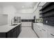 Contemporary kitchen featuring stainless steel appliances, island, and ample storage at 4444 Robin Hood Trl W, Sarasota, FL 34232