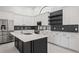 Updated kitchen with stainless appliances, spacious island, and decorative backsplash at 4444 Robin Hood Trl W, Sarasota, FL 34232