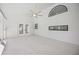 Bright open living room with large windows and ceiling fan at 4444 Robin Hood Trl W, Sarasota, FL 34232