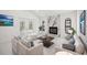 Bright living room with a marble fireplace, stylish furniture and ample natural light at 4444 Robin Hood Trl W, Sarasota, FL 34232
