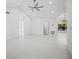 Bright, open living room featuring high ceilings, fan, and expansive windows for ample natural light at 4444 Robin Hood Trl W, Sarasota, FL 34232
