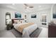 Serene main bedroom featuring neutral tones, tray ceiling, and access to the pool area at 4444 Robin Hood Trl W, Sarasota, FL 34232