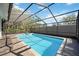 Beautiful pool with spa inside of a screened-in enclosure and paver deck at 4444 Robin Hood Trl W, Sarasota, FL 34232
