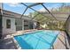 Beautiful backyard pool with screen enclosure, brick pavers, and open patio area for outdoor entertaining at 4444 Robin Hood Trl W, Sarasota, FL 34232