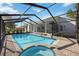 Pool with a brick patio, spa, and screened enclosure at 4444 Robin Hood Trl W, Sarasota, FL 34232