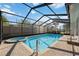 Backyard swimming pool and jacuzzi featuring a screened-in enclosure with paver deck at 4444 Robin Hood Trl W, Sarasota, FL 34232