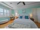 Bright main bedroom featuring a tray ceiling, soft blue walls, with an adjoining office at 4510 Murcia Blvd # 16, Sarasota, FL 34238