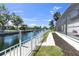 Tranquil backyard featuring a canal view, fenced yard, and manicured landscaping at 4624 Blue Marlin Dr, Bradenton, FL 34208
