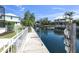Picturesque waterfront backyard with seawall, dock, and views of neighboring homes at 4624 Blue Marlin Dr, Bradenton, FL 34208