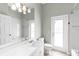 Bright bathroom with white vanity, shower, and walk-out access at 4624 Blue Marlin Dr, Bradenton, FL 34208