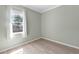 Cozy bedroom with wood-look flooring and a bright window offering natural light at 4624 Blue Marlin Dr, Bradenton, FL 34208