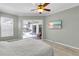 Light and airy bedroom offering serene views and access to the outdoor patio and pool at 4624 Blue Marlin Dr, Bradenton, FL 34208