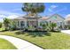Inviting home with manicured lawn, lush landscaping, palm trees and attached portico at 4624 Blue Marlin Dr, Bradenton, FL 34208