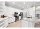 Bright kitchen features white cabinets, marble countertops, and stainless steel appliances at 4624 Blue Marlin Dr, Bradenton, FL 34208