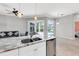 Open kitchen featuring granite counters, stainless steel appliances, and seamless access to the outdoor pool area at 4624 Blue Marlin Dr, Bradenton, FL 34208