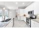 Modern kitchen features stainless steel appliances, stone countertops, and white cabinets at 4624 Blue Marlin Dr, Bradenton, FL 34208