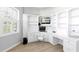 A bright home office boasts built in desk and cabinets with a chair at 4624 Blue Marlin Dr, Bradenton, FL 34208