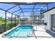 A screened in pool features cool clear water, brick patio and canal view at 4624 Blue Marlin Dr, Bradenton, FL 34208