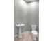 Convenient powder room with pedestal sink and neutral decor at 4624 Blue Marlin Dr, Bradenton, FL 34208