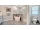 Modern bathroom showcases a standalone tub, shower, and toilet, with stylish tile accents at 4912 Old Oakleaf Dr, Sarasota, FL 34233