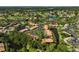 Aerial view of a condo community featuring red tile roofs, lush landscaping, and tranquil ponds at 5201 Lake Village Dr # 14, Sarasota, FL 34235
