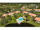 Aerial view of the condo community, showcasing a community pool near a lake at 5201 Lake Village Dr # 14, Sarasota, FL 34235