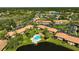 Aerial view showcasing a condo community with a pool, scenic ponds, and lush landscaping at 5201 Lake Village Dr # 14, Sarasota, FL 34235