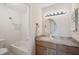Well-lit bathroom featuring a vanity with a sink and a bathtub with shower at 5201 Lake Village Dr # 14, Sarasota, FL 34235
