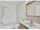 Bright bathroom with tiled shower-tub combination and a vanity with ample counter space at 5201 Lake Village Dr # 14, Sarasota, FL 34235