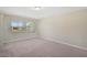Carpeted bedroom with a window providing natural light and a view of the outside at 5201 Lake Village Dr # 14, Sarasota, FL 34235