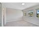 Neutral bedroom featuring carpet floors and two windows, and a closet, creating a serene retreat at 5201 Lake Village Dr # 14, Sarasota, FL 34235