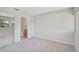 Neutral-toned bedroom with carpeted floors, a mirrored closet, and an ensuite bathroom with walk-in shower at 5201 Lake Village Dr # 14, Sarasota, FL 34235