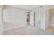 Carpeted bedroom with a mirrored closet door and an adjoining bathroom at 5201 Lake Village Dr # 14, Sarasota, FL 34235