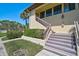 Two-story condo with landscaped entrance, stairs leading up to front door at 5201 Lake Village Dr # 14, Sarasota, FL 34235