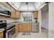 Well-lit kitchen with stainless steel appliances, tile floors, and a breakfast bar overlooking the dining area at 5201 Lake Village Dr # 14, Sarasota, FL 34235