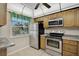 Functional kitchen with stainless steel appliances, ample cabinet space, and tiled floors at 5201 Lake Village Dr # 14, Sarasota, FL 34235