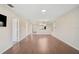 Spacious living area with new wood flooring, large windows, and a view of the front entryway at 5201 Lake Village Dr # 14, Sarasota, FL 34235