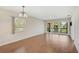 Bright living room featuring hardwood floors, large windows, and a sliding glass door at 5201 Lake Village Dr # 14, Sarasota, FL 34235