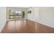 Bright living room with sliding glass doors leading to a balcony, complete with sleek wood flooring at 5201 Lake Village Dr # 14, Sarasota, FL 34235