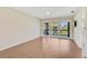 Bright living room with sliding glass doors leading to a balcony, complete with sleek wood flooring at 5201 Lake Village Dr # 14, Sarasota, FL 34235