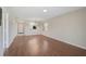 Spacious living area with new wood flooring, large windows, and a view of the front entryway at 5201 Lake Village Dr # 14, Sarasota, FL 34235