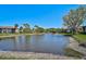 Scenic view of a tranquil pond surrounded by lush greenery and well-maintained condo buildings at 5201 Lake Village Dr # 14, Sarasota, FL 34235