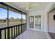 Enclosed patio featuring sliding glass door and water views surrounded by lush greenery at 5201 Lake Village Dr # 14, Sarasota, FL 34235