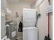 Efficient utility room with stacked washer/dryer and water heater at 5201 Lake Village Dr # 14, Sarasota, FL 34235