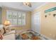 Bright bedroom with shutters, closet space, beach decor and comfortable seating at 600 Sutton Pl # 104, Longboat Key, FL 34228