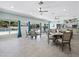 Community dining area featuring ceiling fans, tile flooring, and lovely views of the outdoor pool at 600 Sutton Pl # 104, Longboat Key, FL 34228